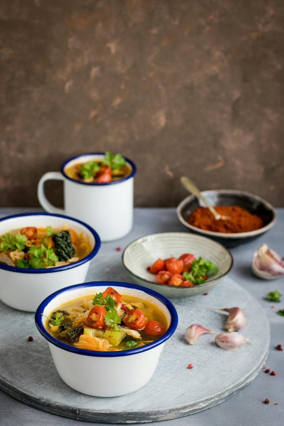 Rustic soup bowls with herbs and garlic.
