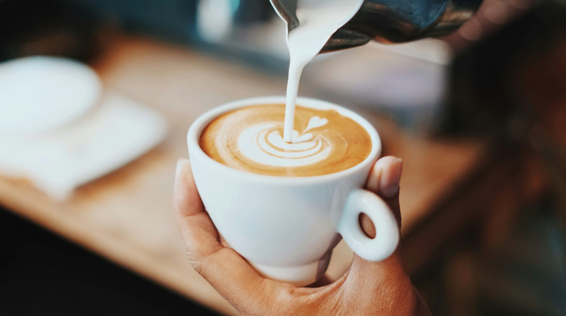 Latte art being poured to perfection.