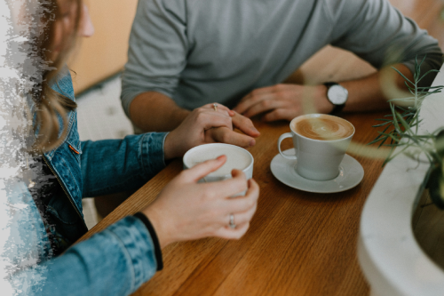 Casual café conversation over warm coffee.