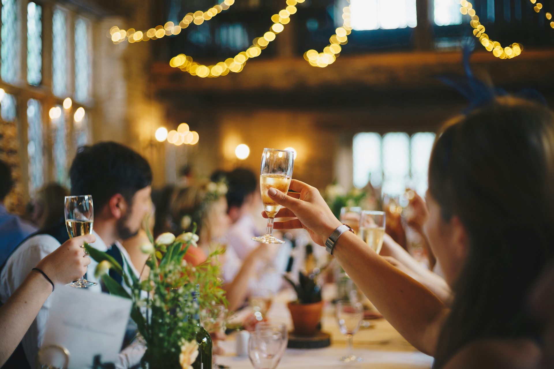 Celebration toast in warmly lit restaurant.